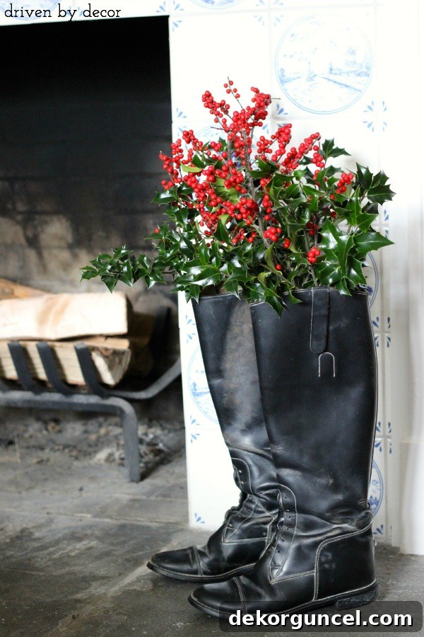 Quintessential New England Christmas Style 19 An intriguing display featuring fresh greenery and vibrant red berries artfully arranged within a pair of elegant black riding boots, serving as a unique holiday decoration.