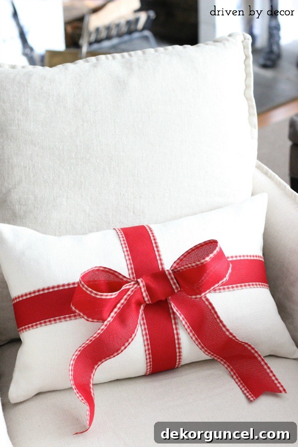 Quintessential New England Christmas Style 20 A creative holiday decorating tip: easily transform an everyday pillow into a festive Christmas accent by adorning it with a simple ribbon to mimic a wrapped gift.