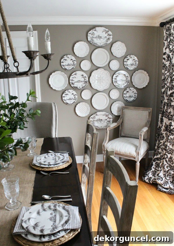 A beautifully decorated dining room in neutral tones, featuring a large wooden table, elegant chairs, and subtle decorative accents. The space exudes an inviting and sophisticated shabby chic aesthetic.