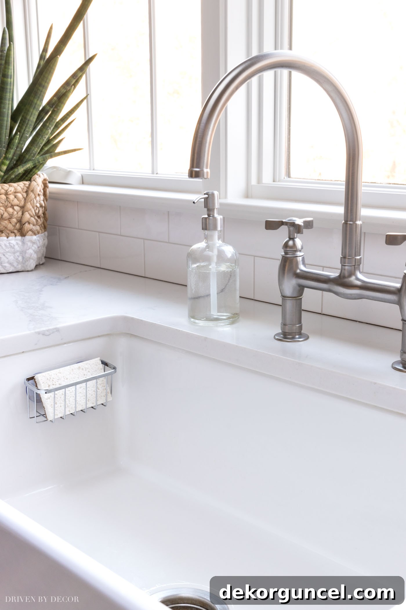 8 Genius Budget Kitchen Hacks 5 An inexpensive suction cup sponge holder is a smart kitchen organization idea for a tidy sink.