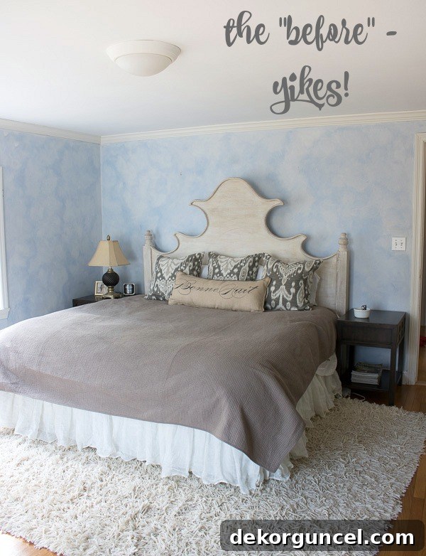 Our master bedroom before the makeover, featuring outdated faux-finished blue walls, an old overhead light, and mismatched furniture, highlighting the need for a complete transformation.