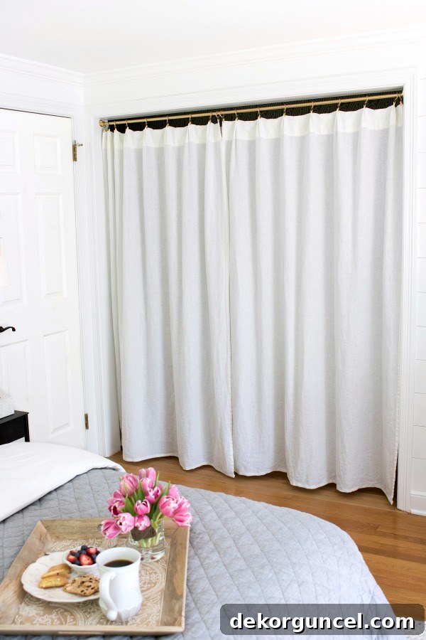 A smart and stylish closet update: the two original doors and center partition were removed and ingeniously replaced with a functional rod and elegant drapes, making for a brilliant design enhancement.