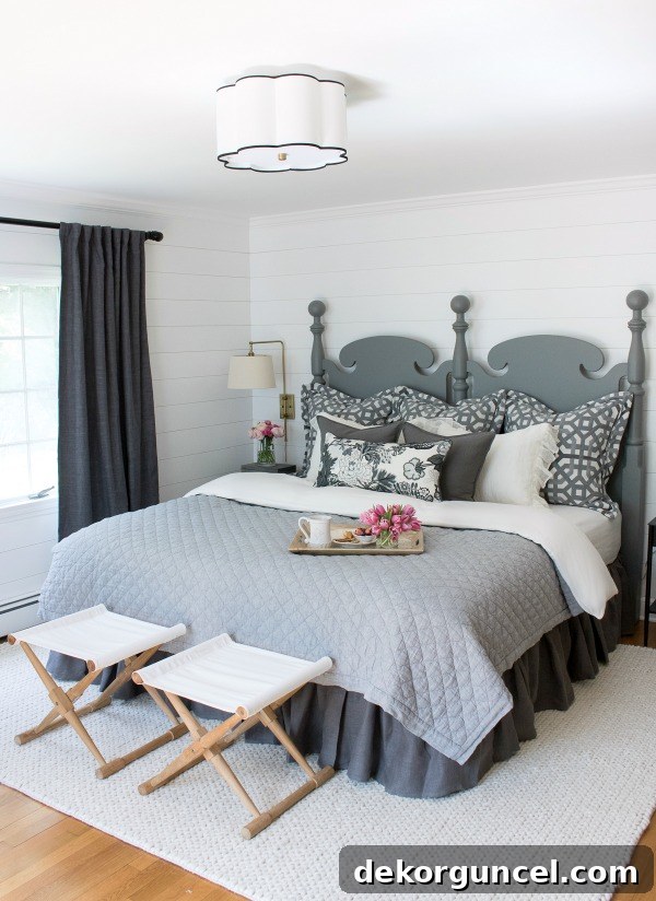 The first master bedroom makeover revealing a serene space with planked walls painted in Farrow & Ball All White, showcasing a soothing neutral decor palette, a significant departure from its previous state.