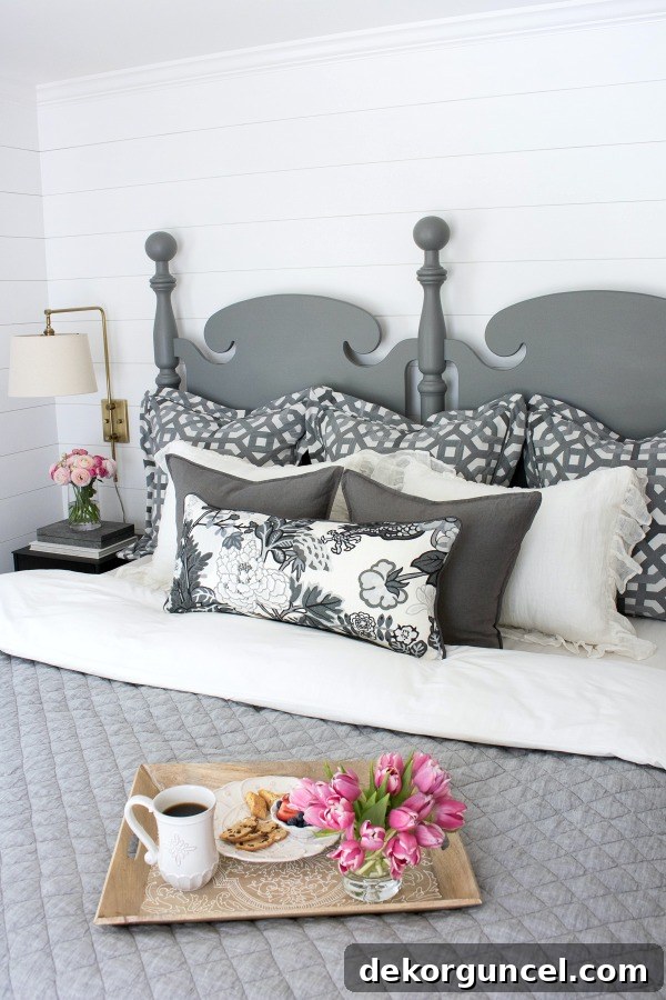 A beautifully layered king-sized bed featuring an array of pillows, including two euro shams, two standard shams, two square decorative pillows, and a rectangular accent pillow, designed for the ultimate pillow enthusiast.