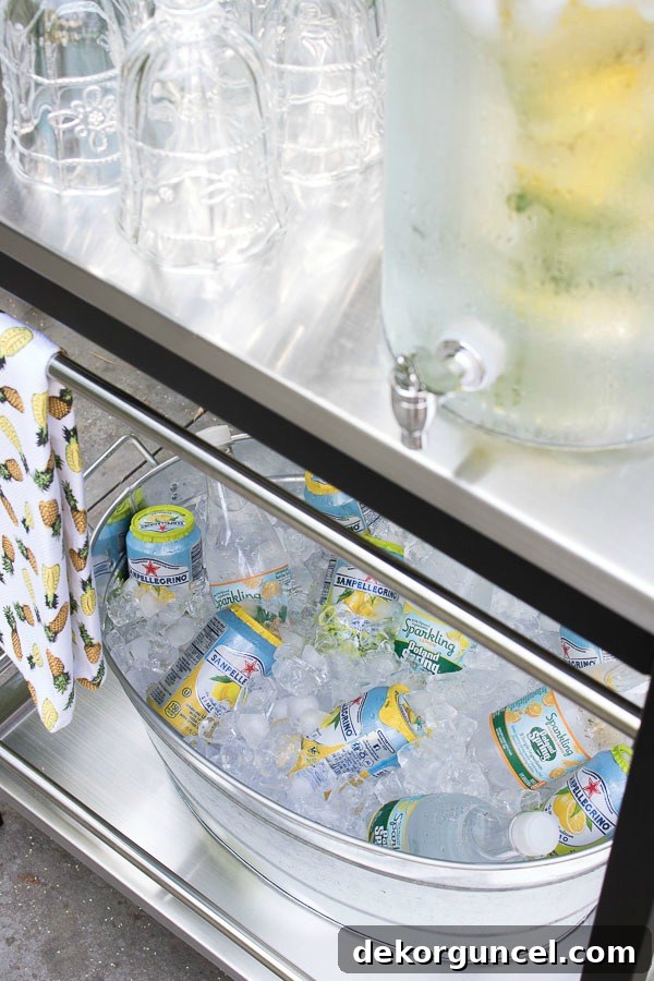 Galvanized tubs and buckets creatively used as outdoor coolers, filled with ice and beverages, perfect for parties.