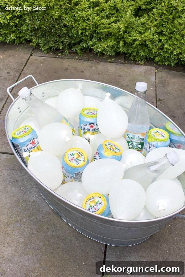 Frozen water balloons chilling beverages in an outdoor cooler, offering a fun and colorful alternative to ice for parties.