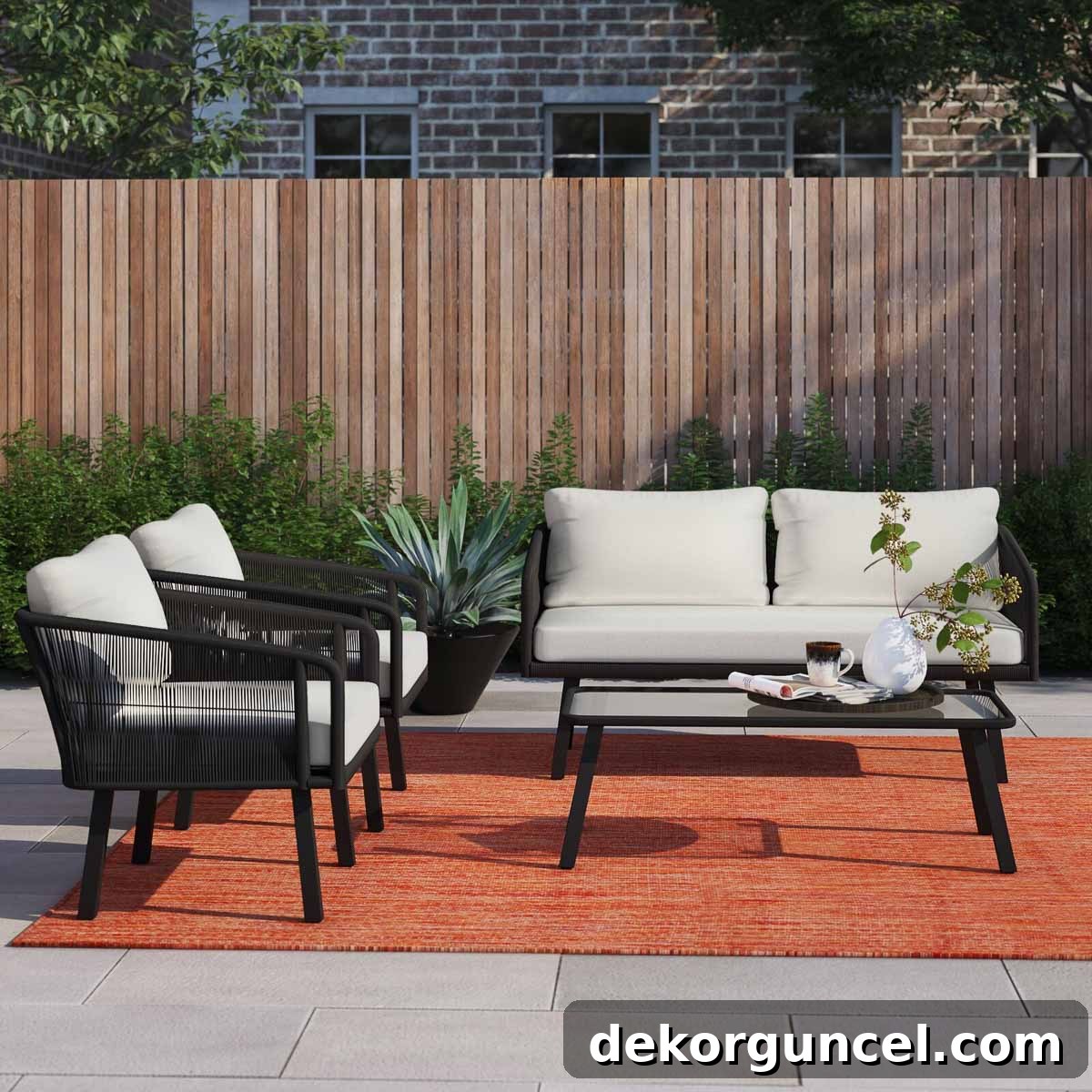 Stylish black wrapped wicker conversation set featuring a sofa, chairs, and coffee table for outdoor lounging.