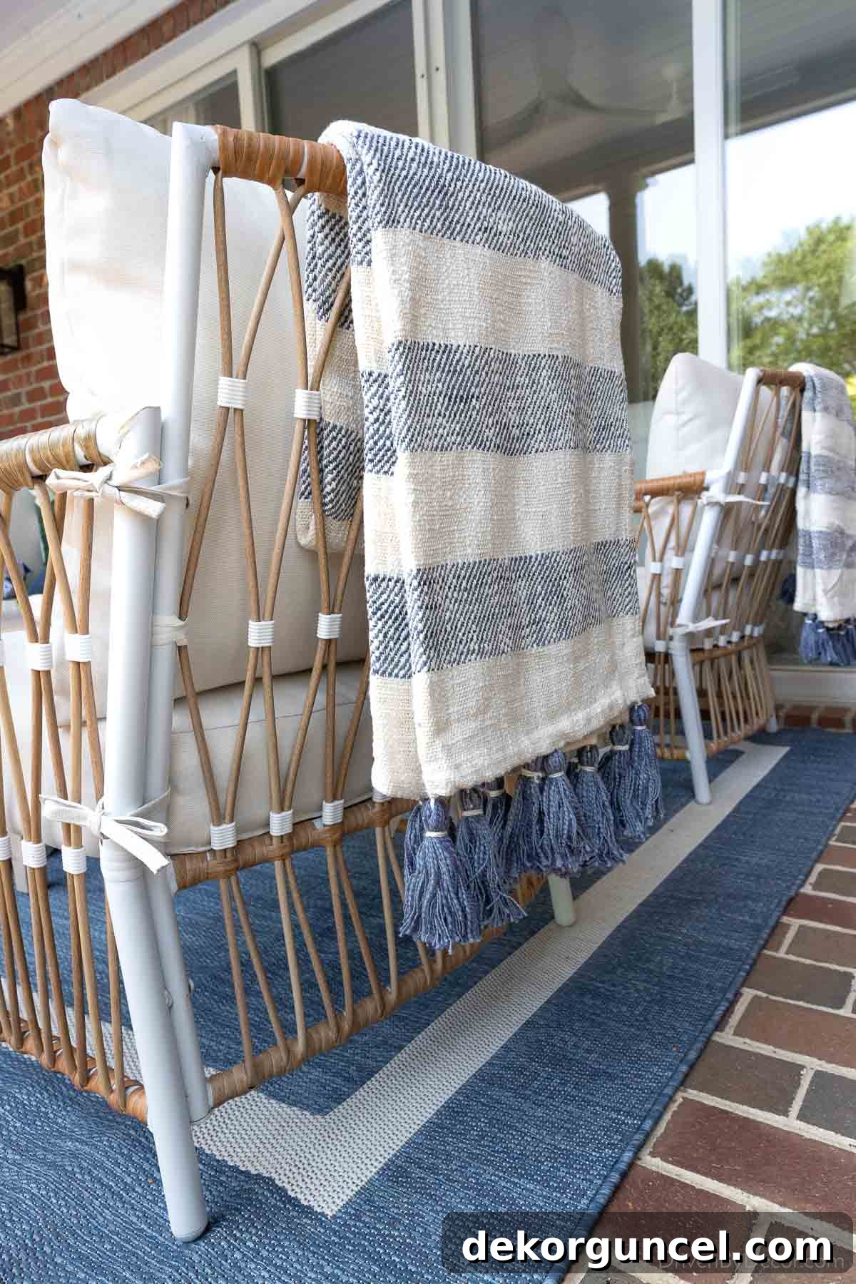 Cozy striped throw blanket draped over an outdoor chair, enhancing comfort and style on a porch or patio.