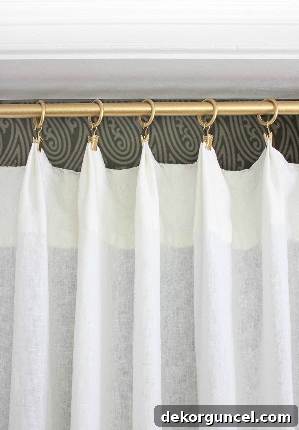 Detail shot of a spray-painted gold curtain rod and rings, part of a chic closet makeover replacing bi-fold doors.