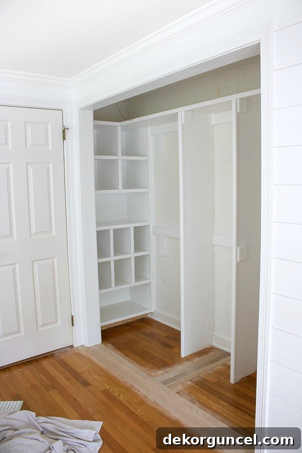 Closet makeover in progress, showing the wide opening after bi-fold doors have been removed and before curtains are installed.