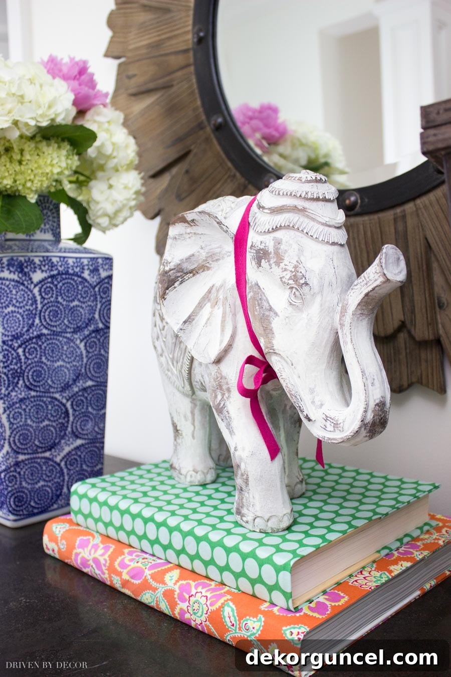 My Top 10 DIY Home Projects 16 Stylishly arranged books with decorative fabric covers on a shelf, demonstrating how easy no-sew fabric book covers can enhance home decor with seasonal color and pattern.