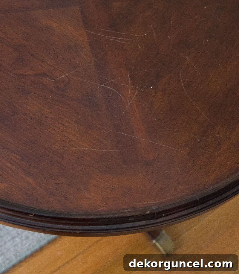 My Top 10 DIY Home Projects 17 A 'before' image of an old, dark-stained end table, showing visible scratches and wear on its surface, highlighting its need for refinishing and restoration.