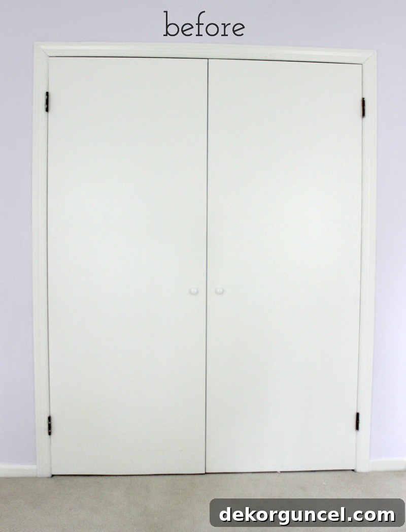My Top 10 DIY Home Projects 19 Before image of a plain, flat slab closet door in a bedroom, highlighting its unadorned and somewhat cheap appearance before a DIY makeover.