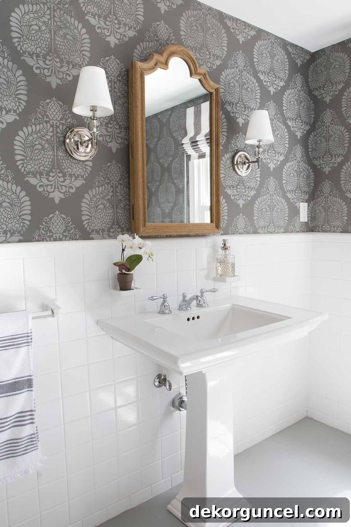 My Top 10 DIY Home Projects 6 Powder room sink area featuring a wall adorned with elegant stencils, creating a sophisticated, wallpaper-like pattern on the dark gray walls, showcasing a successful budget-friendly makeover.