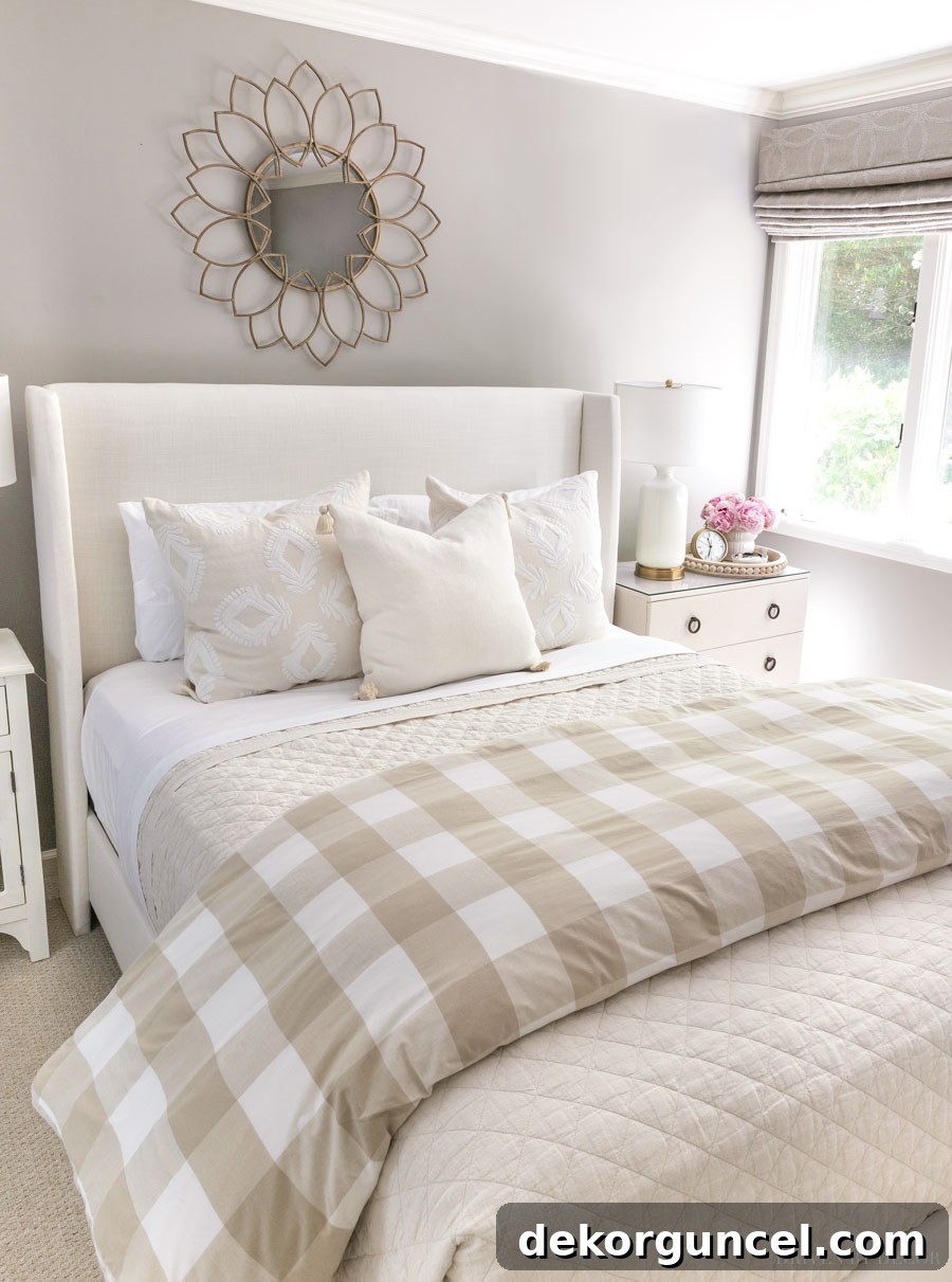 A guest room featuring an upholstered bed and walls painted in Pratt & Lambert Ever Classic, a rich neutral color with significant depth.