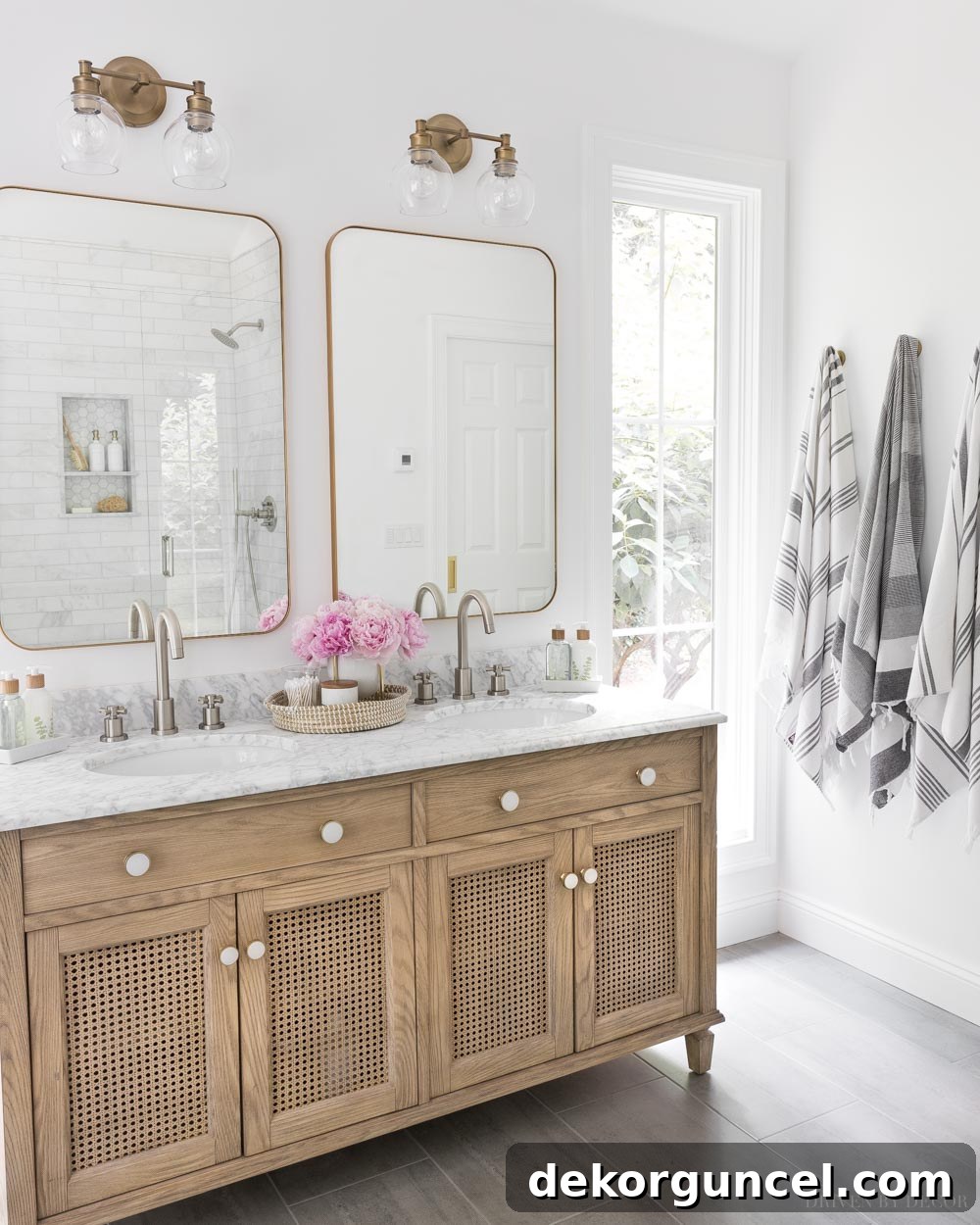 Striking bathroom design featuring a sophisticated mix of brushed nickel faucets with contrasting brass and gold mirrors and lighting fixtures.