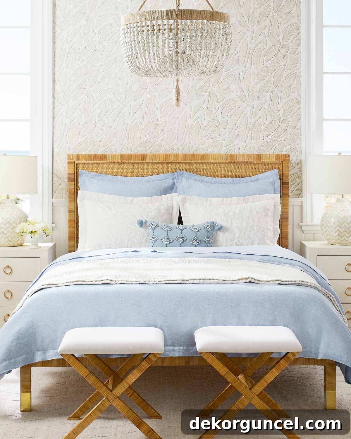 Queen bed with a decorative pair of x-base rattan stools at the foot, perfect for guest luggage or seating