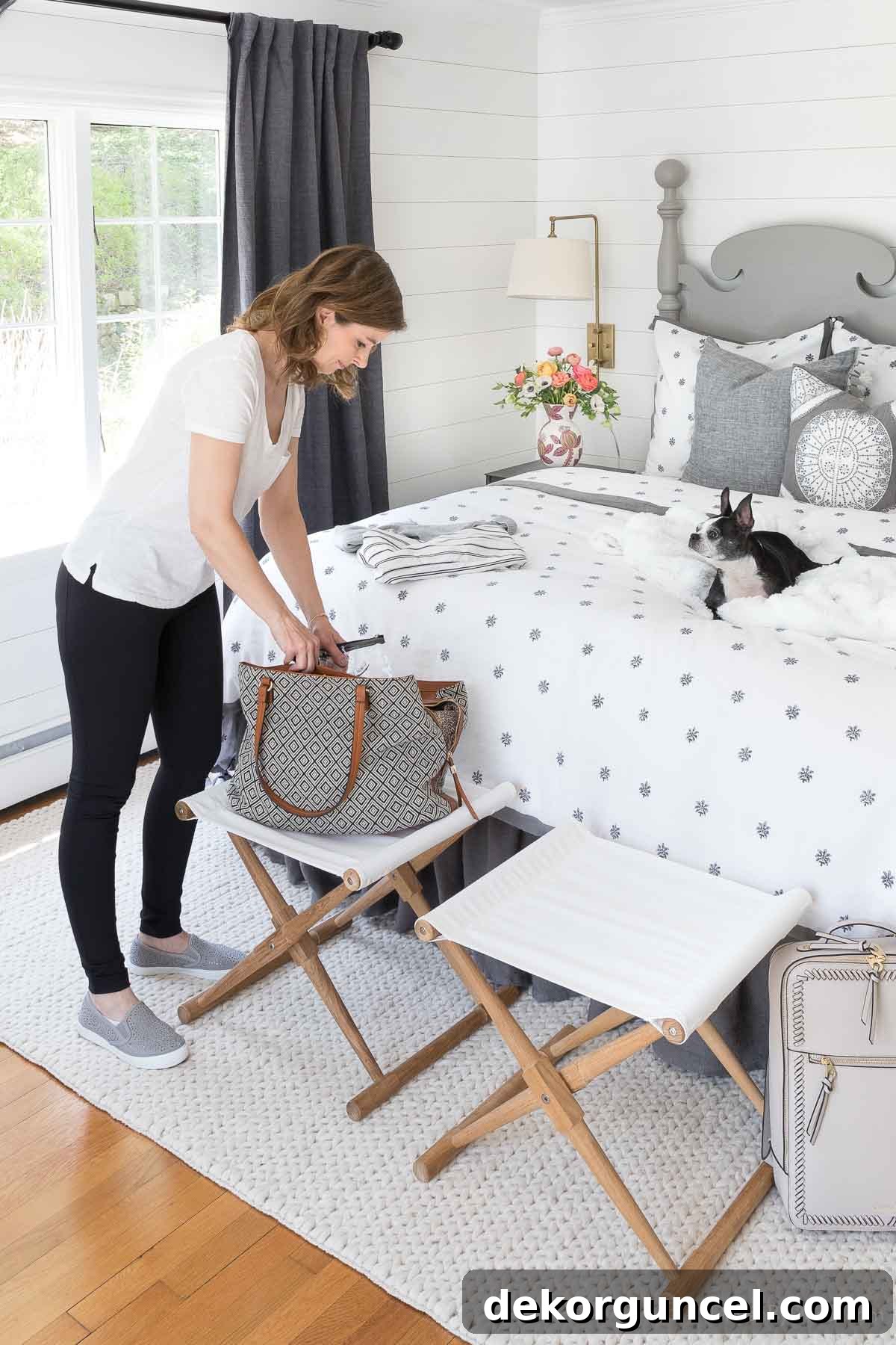 Practical pair of folding stools at the end of a bed, ideal for packing luggage or as a temporary bag rest