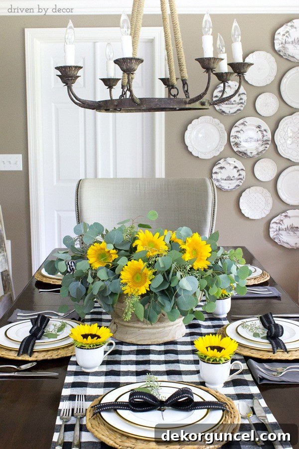 Tall tablescape with sunflowers in a wood bowl, black and white buffalo check table runner and sunflowers in teacups