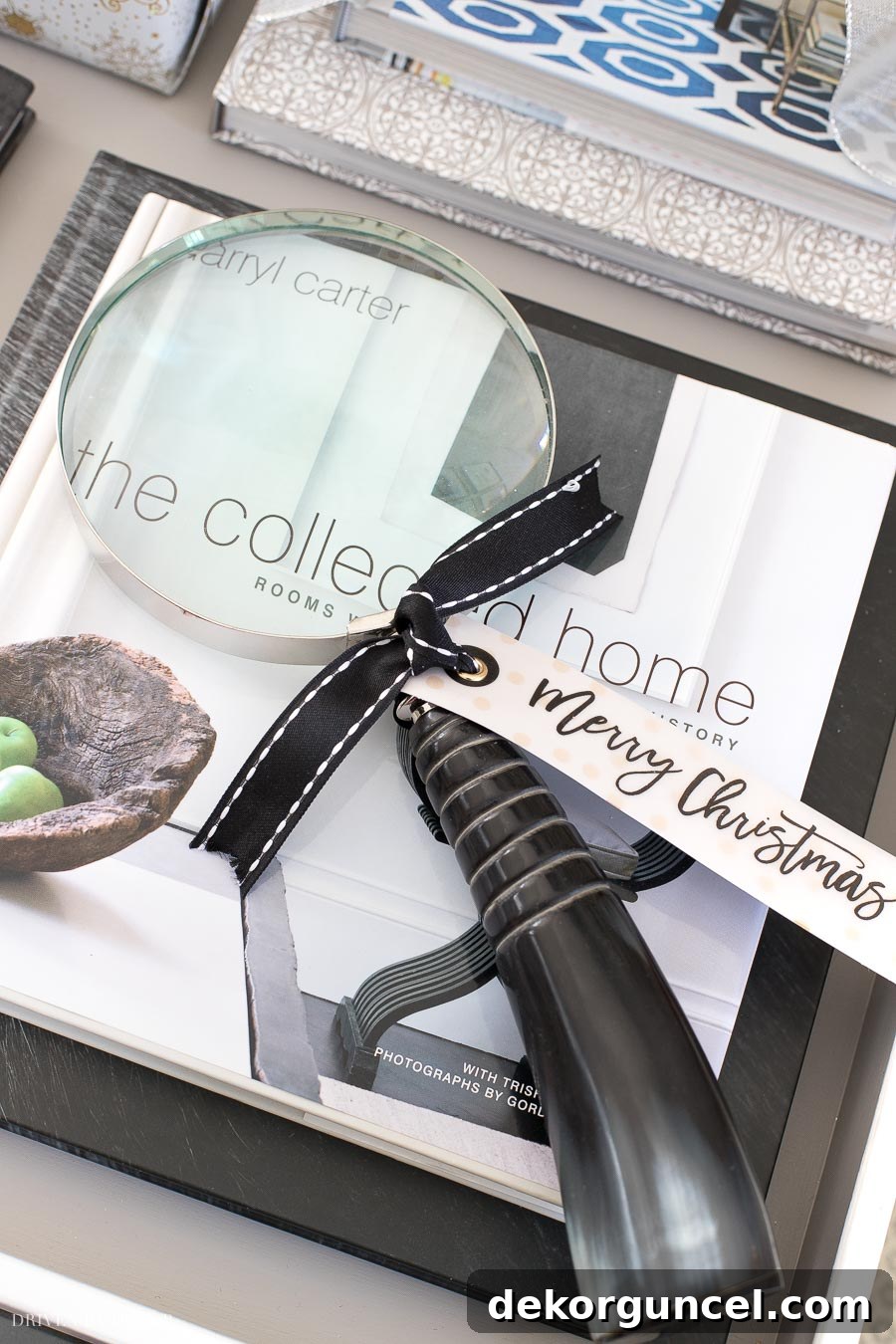 A decorative magnifying glass with a festive tag, showcasing versatile coffee table book toppers.