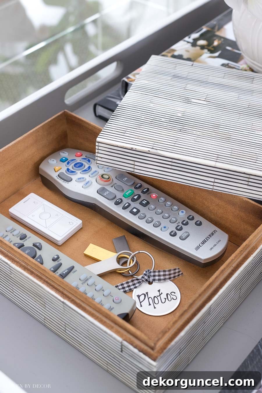 A beautiful bone box serving as stylish storage for remotes on a coffee table, a key coffee table styling tip.