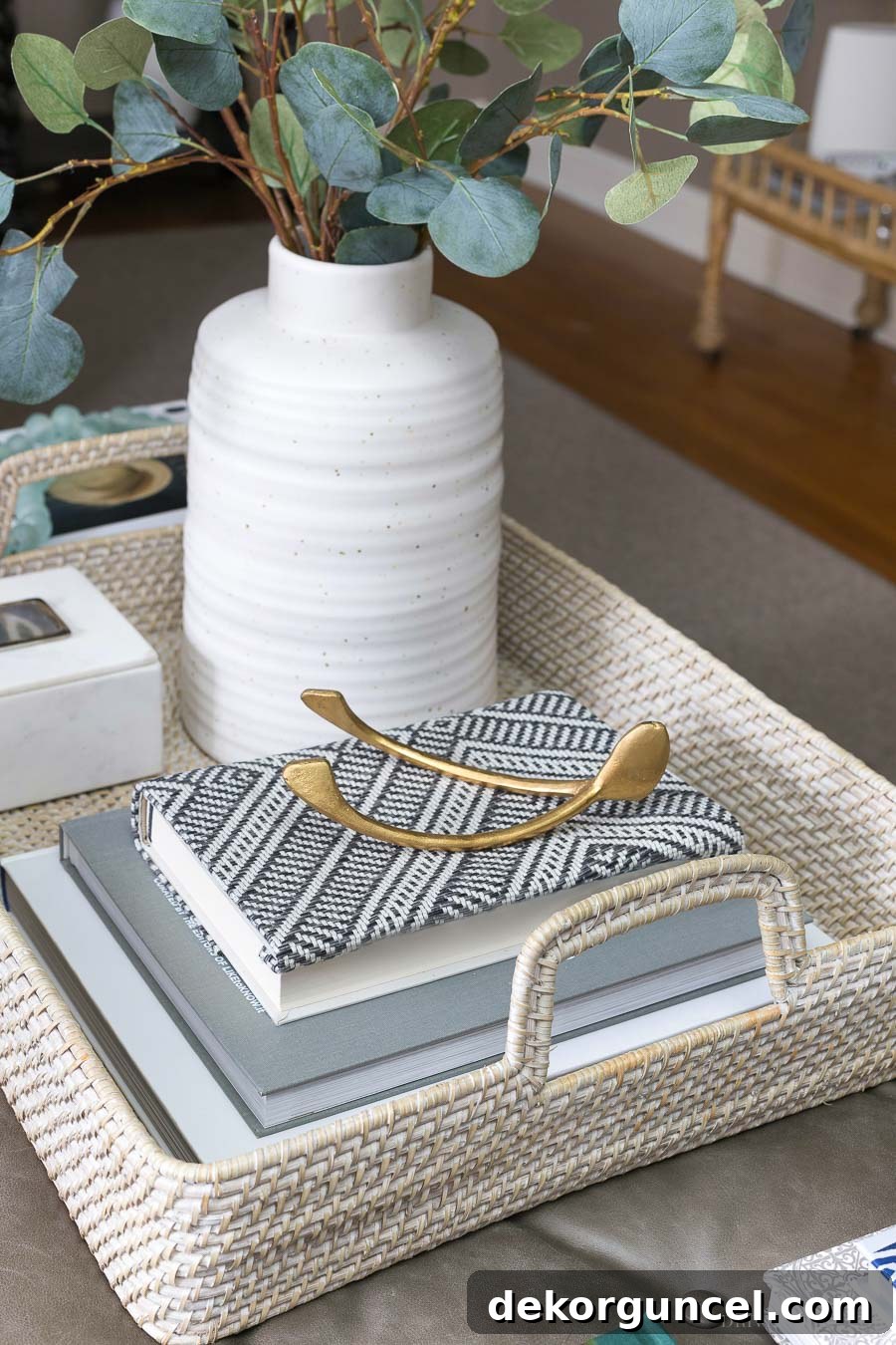 The perfect coffee table tray: A large whitewash rattan serving tray adds brightness and texture to a living room ottoman.