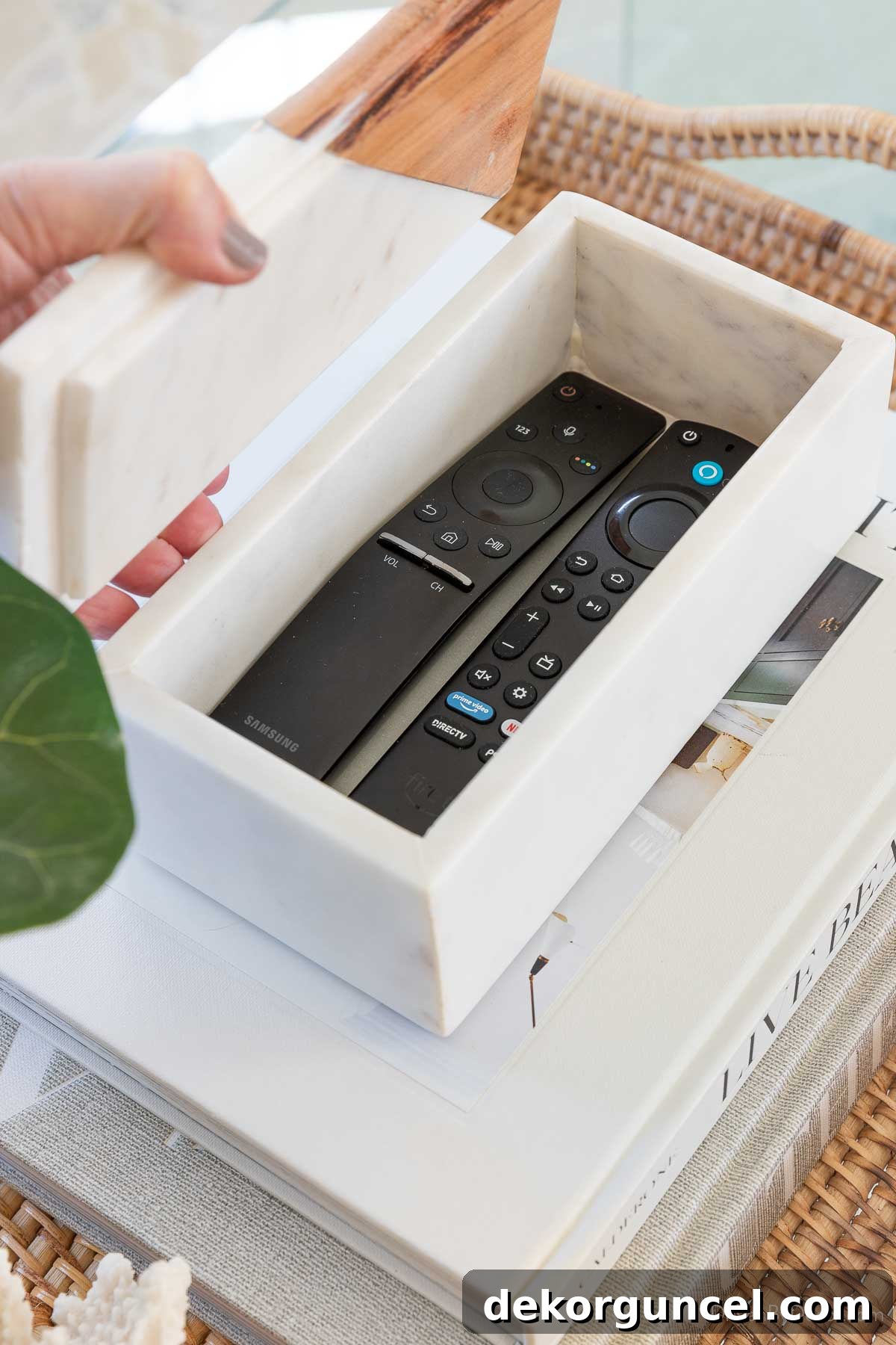 Remote controls neatly stored in a decorative marble box, showcasing practical coffee table organization.