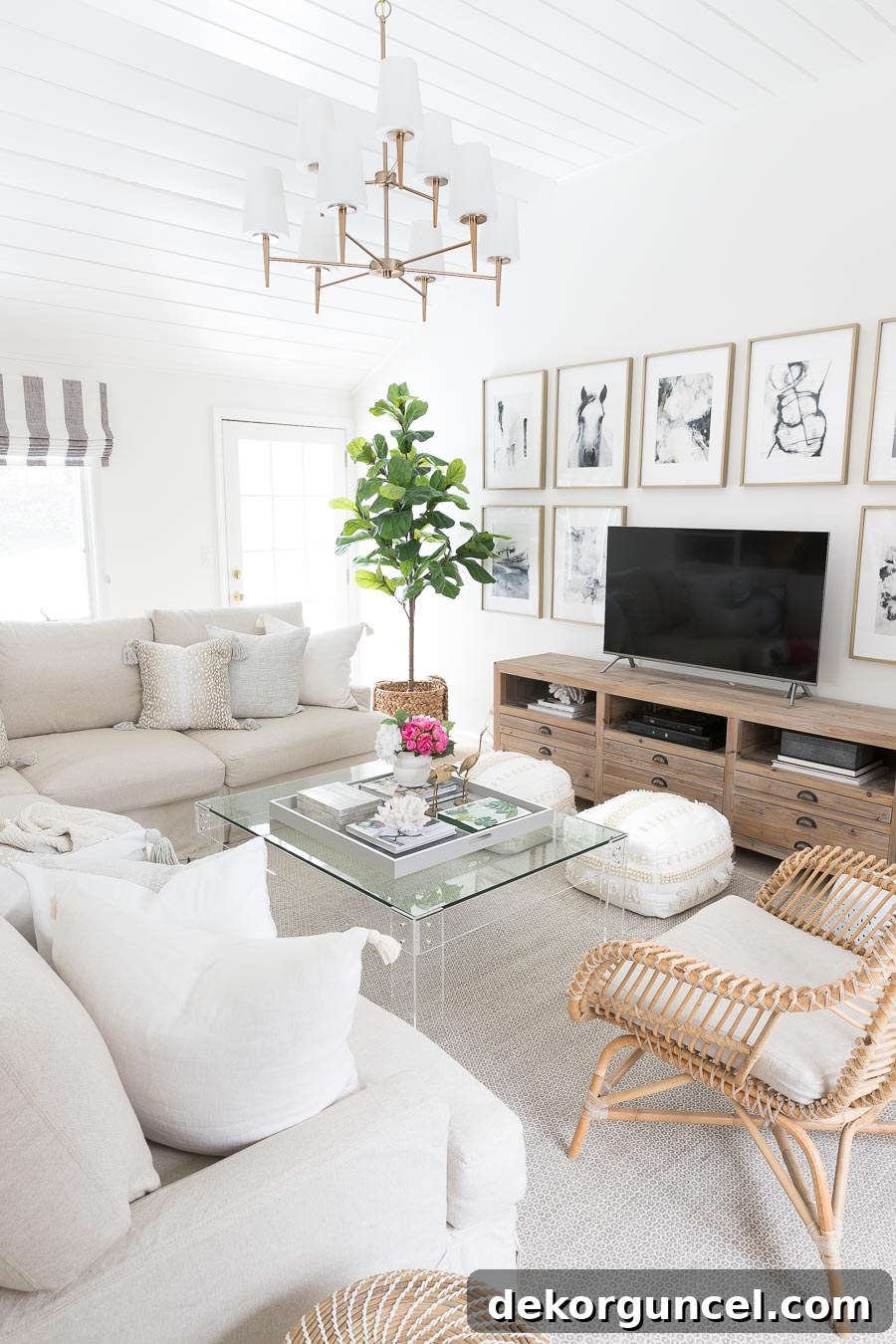 A beautifully styled family room coffee table, showcasing a mix of decor elements including a large tray, books, plants, and decorative objects.