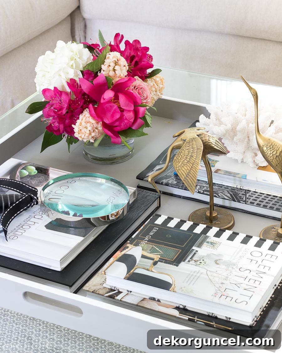 Fresh flowers in a vase on a coffee table, highlighting one of the six essential coffee table decor tips for adding life.