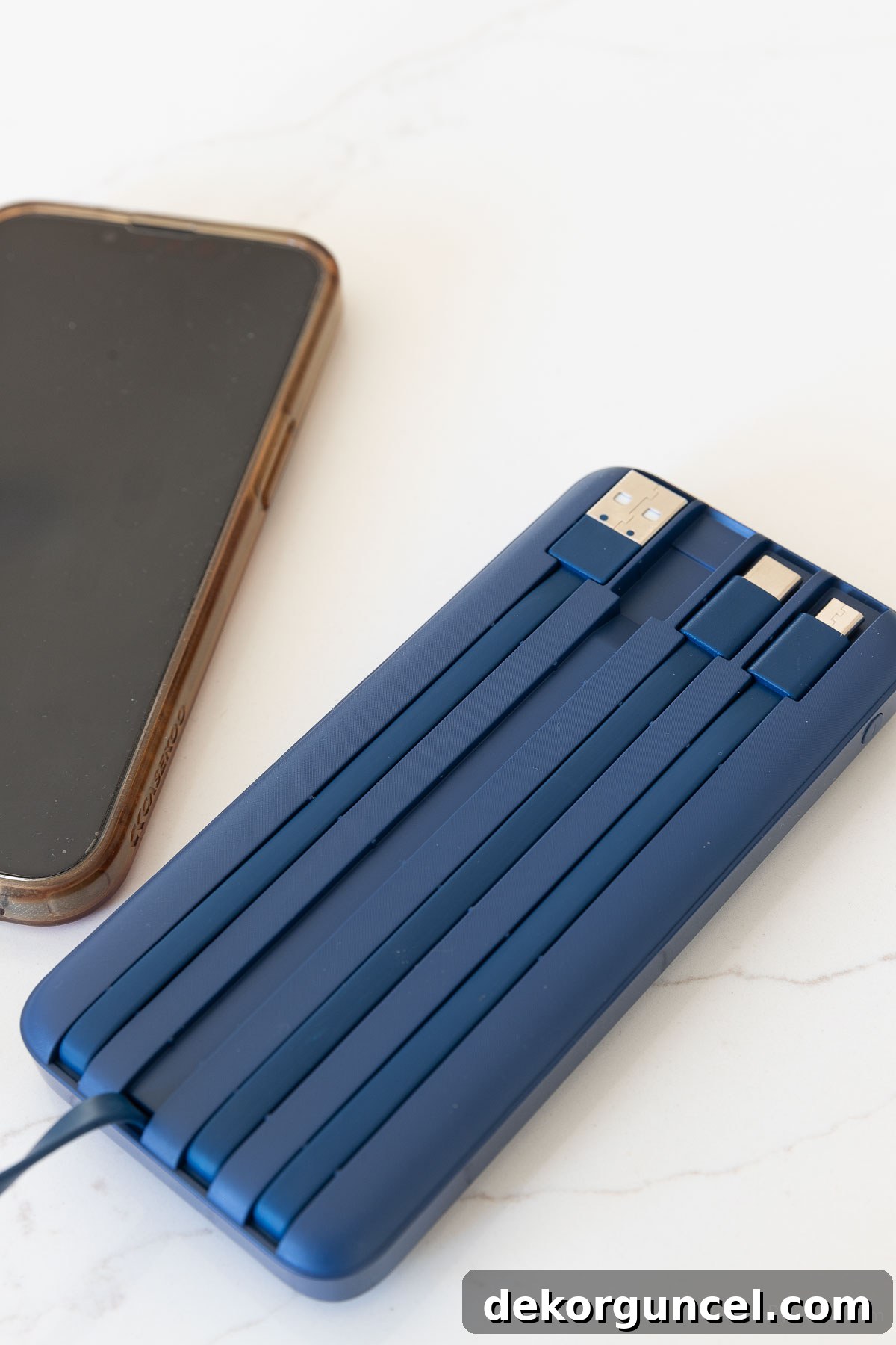 Portable power bank with integrated charging cords neatly stored on the back.