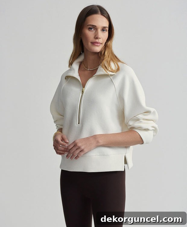 Elegant ribbed half-zip sweatshirt with a prominent gold zipper and large, stylish collar.