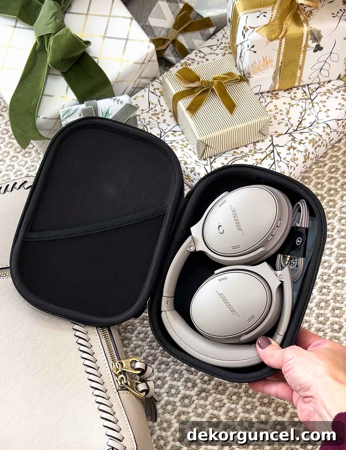 Premium Bose noise-cancelling headphones, folded compactly in their carrying case.