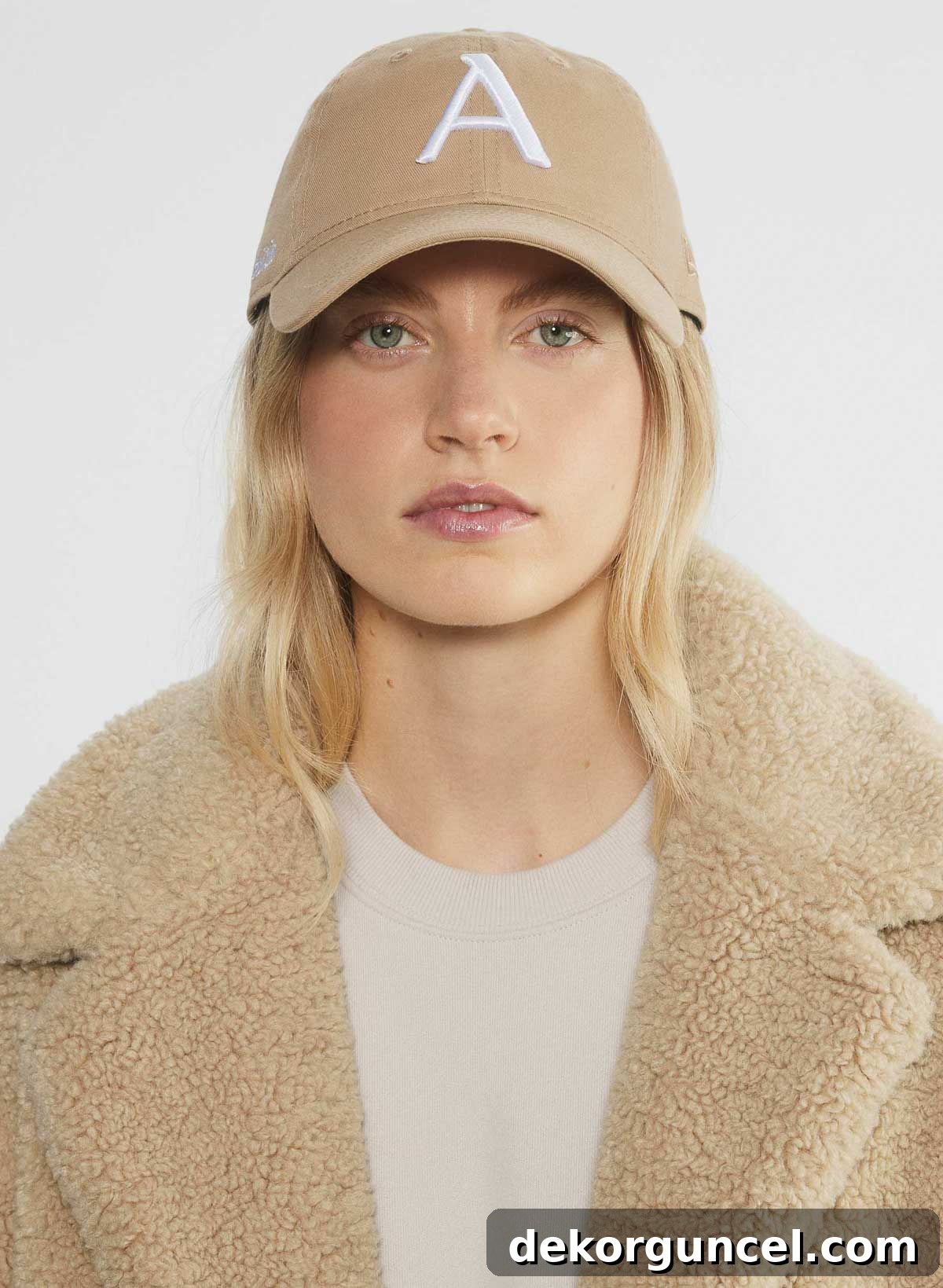 A young woman wearing a stylish Aritzia baseball cap, showcasing a popular fashion accessory.