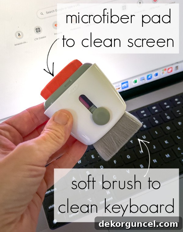 Compact laptop cleaning tool with a brush on one end and a microfiber pad on the other.