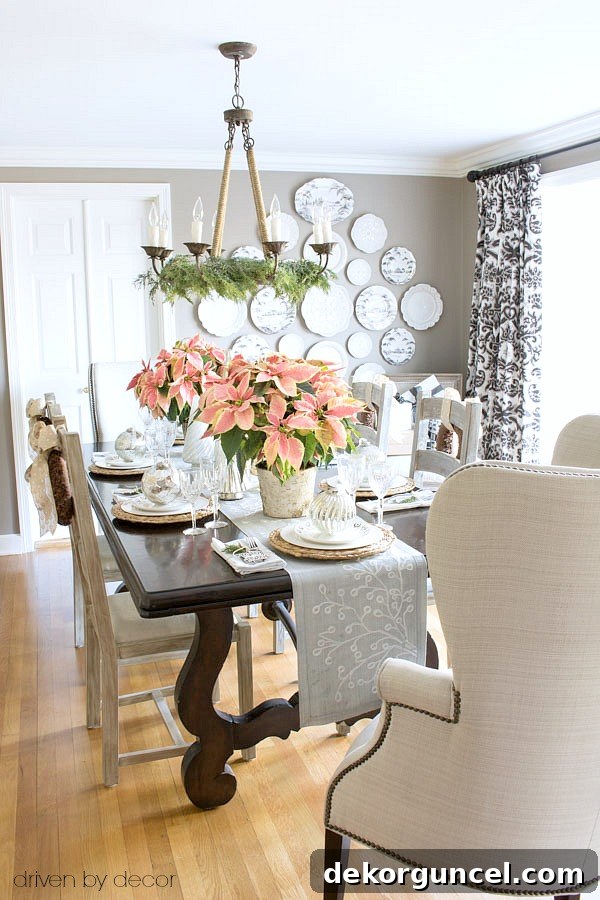Christmas home tour - dining room decorated with pink poinsettias and gold and silver ornaments and decorative trees