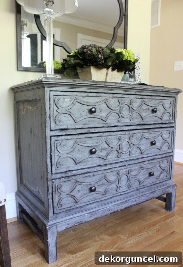 Our Foyer's Stunning Transformation 2 Beautiful gray distressed wood chest of drawers for a welcoming foyer