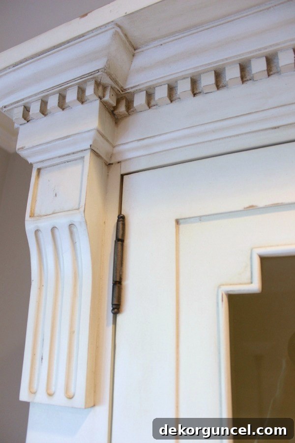 Our Foyer's Stunning Transformation 10 Detail of the antiqued white finish and intricate craftsmanship of Restoration Hardware's St. James Cabinet