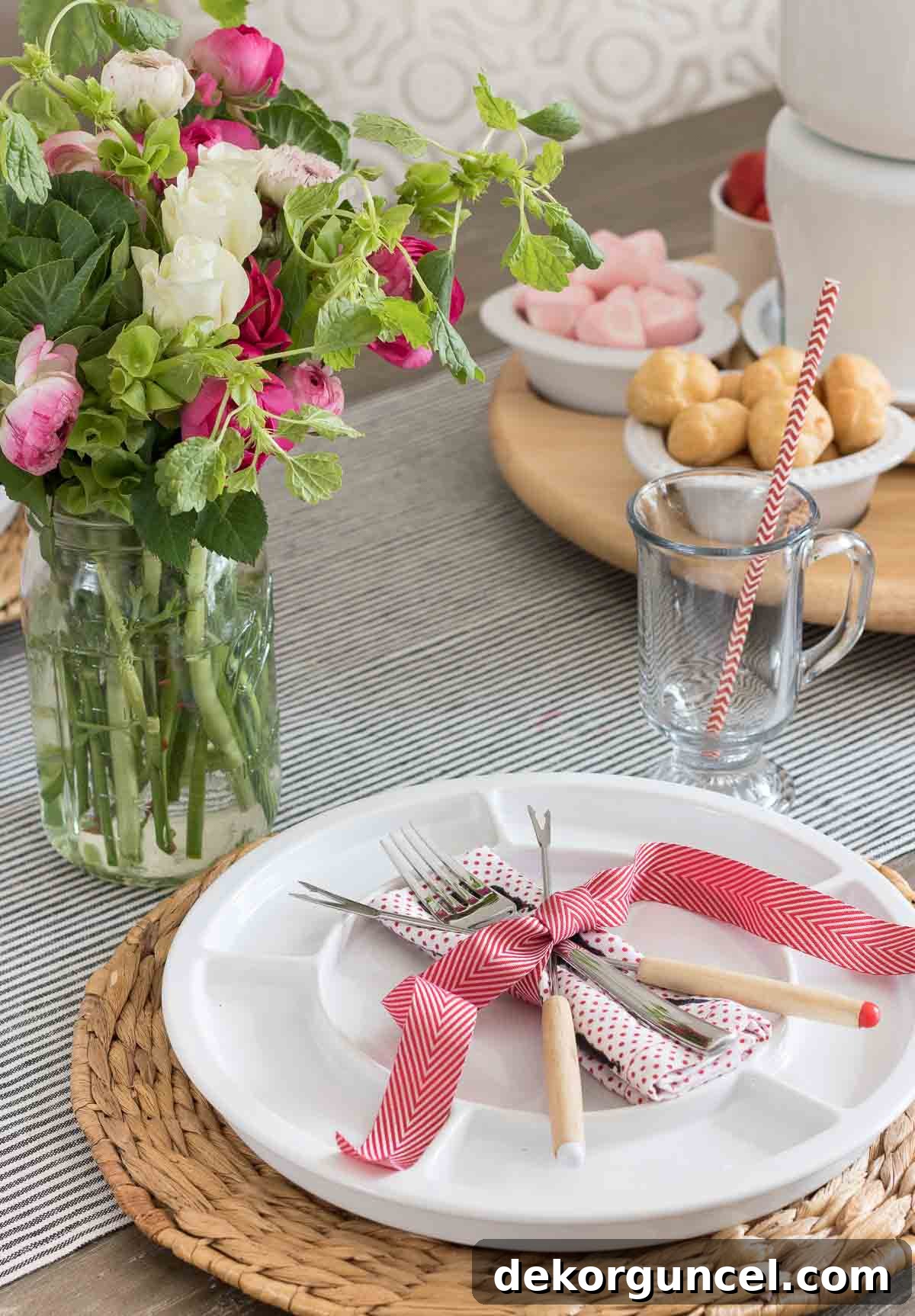 The Art of Fondue Table Presentation 3 Fondue forks elegantly crossed and tied with a festive ribbon on a decorative fondue plate