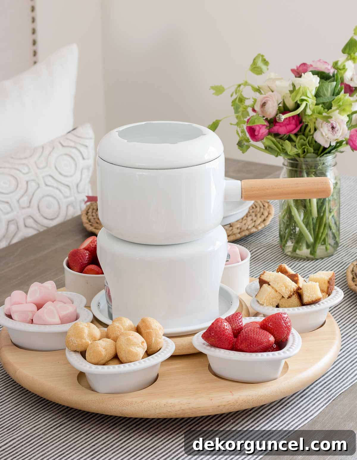The Art of Fondue Table Presentation 5 Variety of sweet fondue dippers arranged in heart-shaped bowls around a fondue pot on a spinner