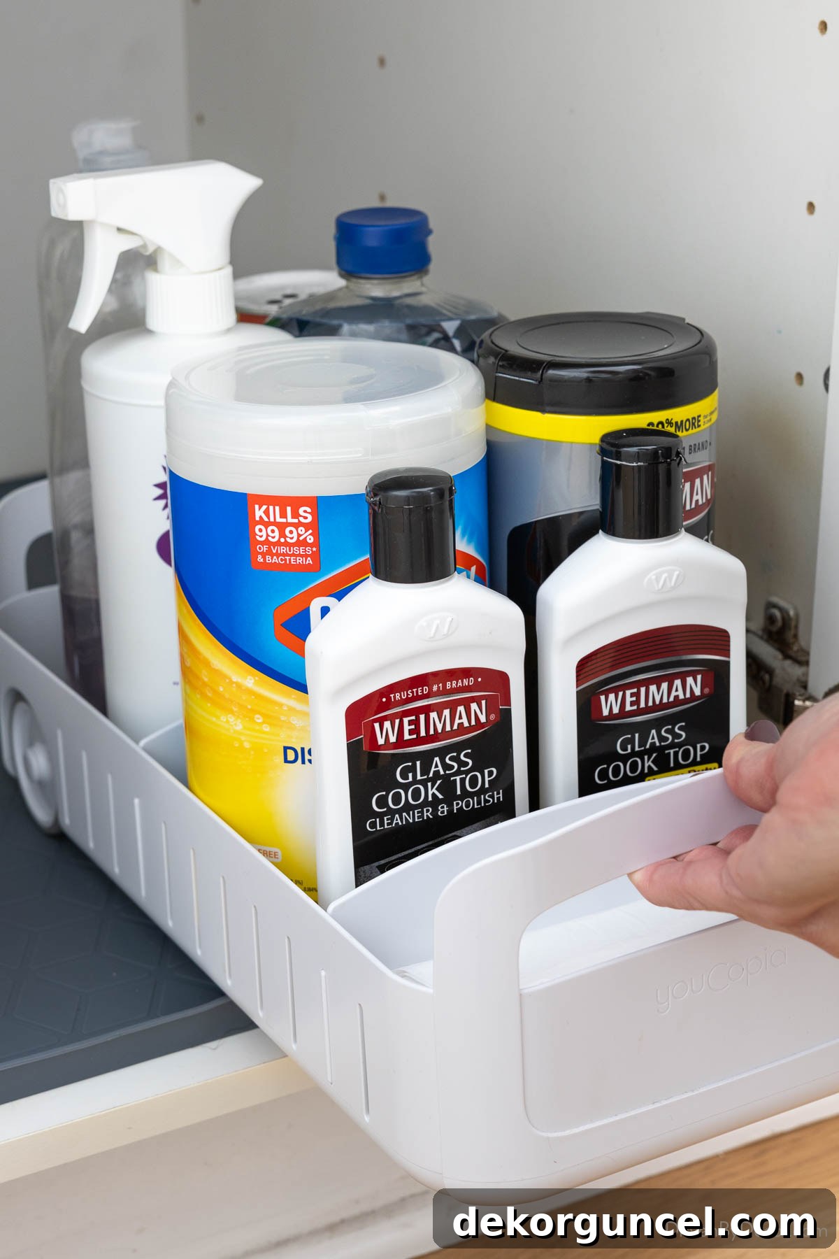 Organizing Under the Kitchen Sink: A Guide to a Tidy Space 12 White rolling organizer filled with cleaning supplies.