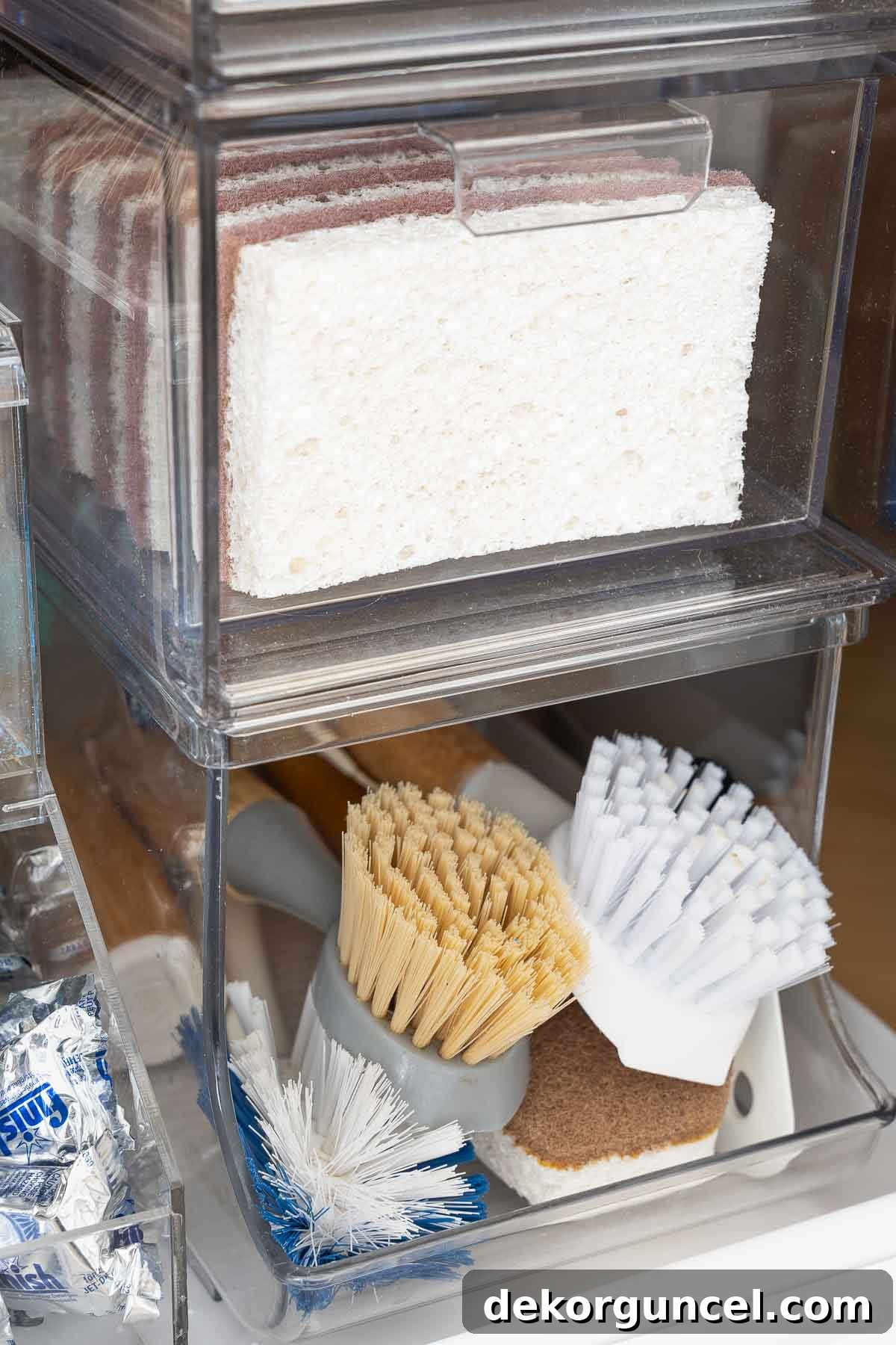 Organizing Under the Kitchen Sink: A Guide to a Tidy Space 15 Acrylic drawers stacked on a can organizer holding scrub brushes.