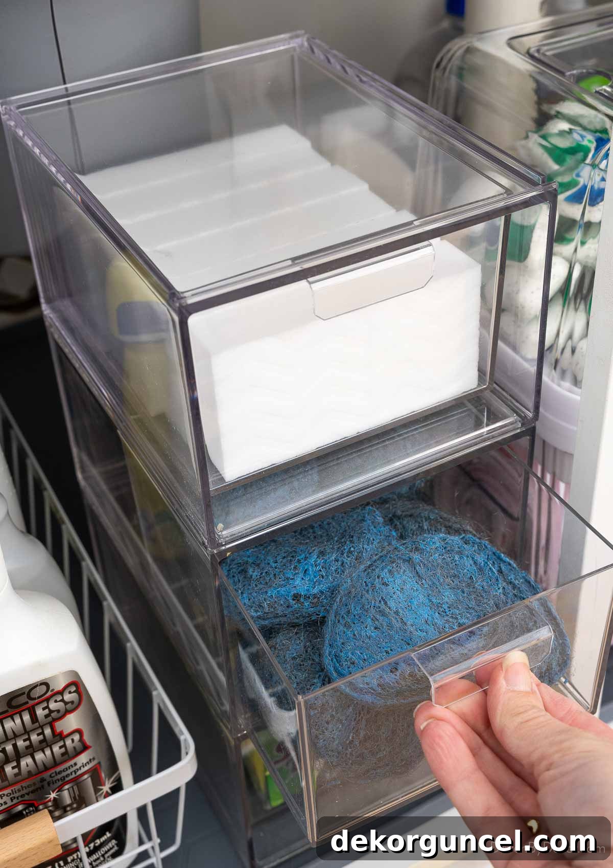 Organizing Under the Kitchen Sink: A Guide to a Tidy Space 18 Stackable acrylic drawers with a drawer open to soap pads.