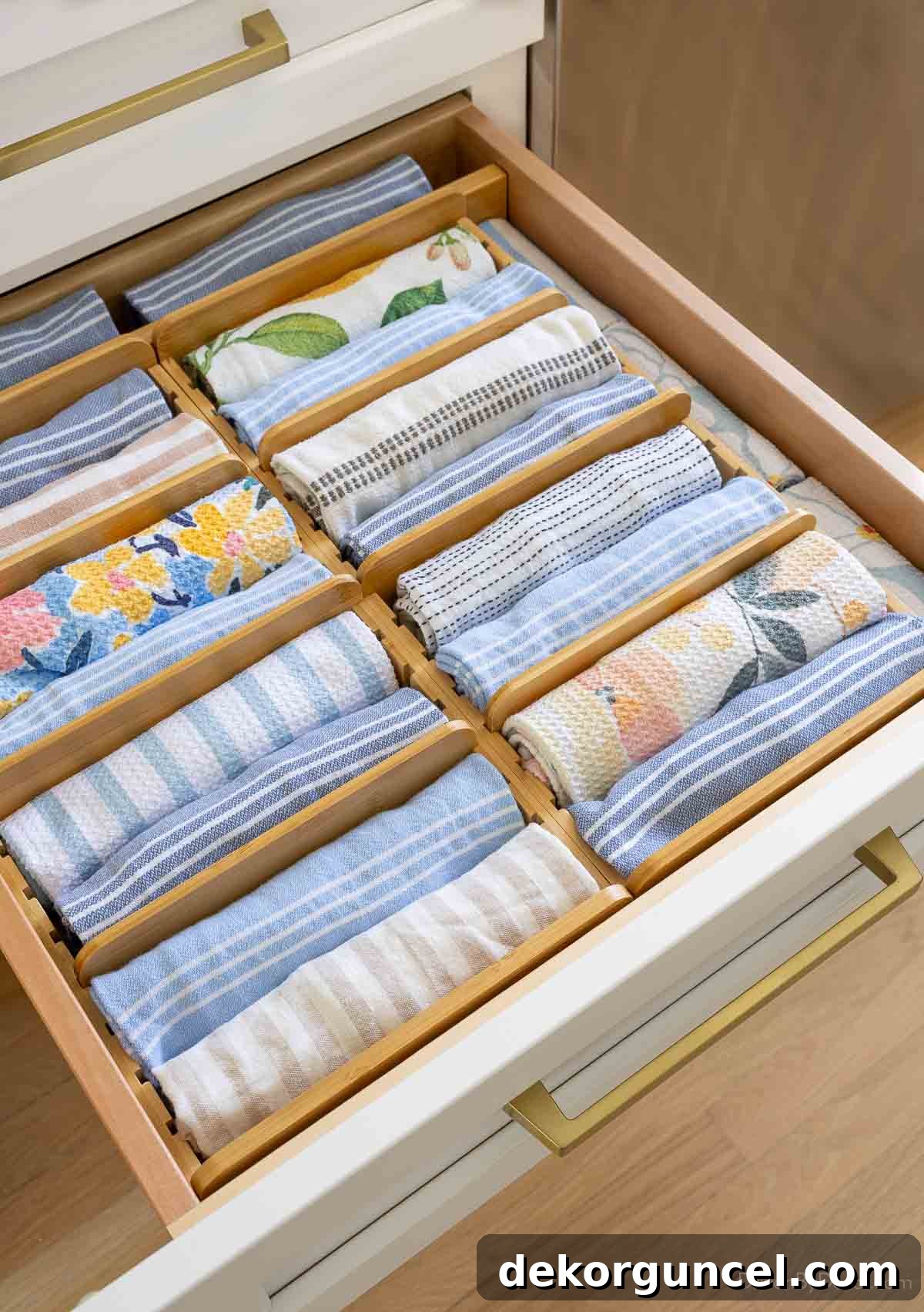 Organizing Under the Kitchen Sink: A Guide to a Tidy Space 6 Bamboo kitchen towel drawer organizer with rolled towels.
