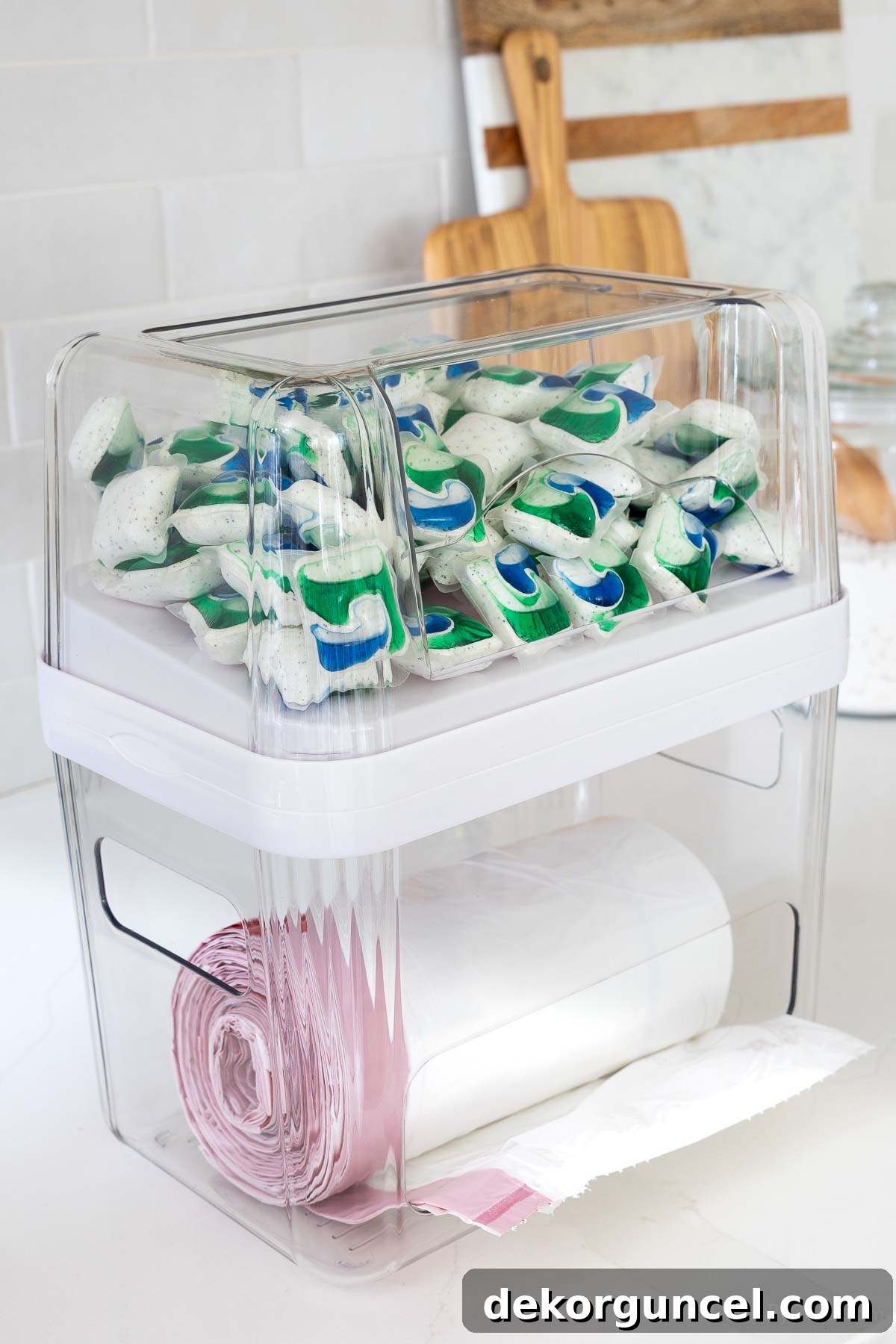 Organizing Under the Kitchen Sink: A Guide to a Tidy Space 10 Organizer holding trash bags and dishwasher pods.